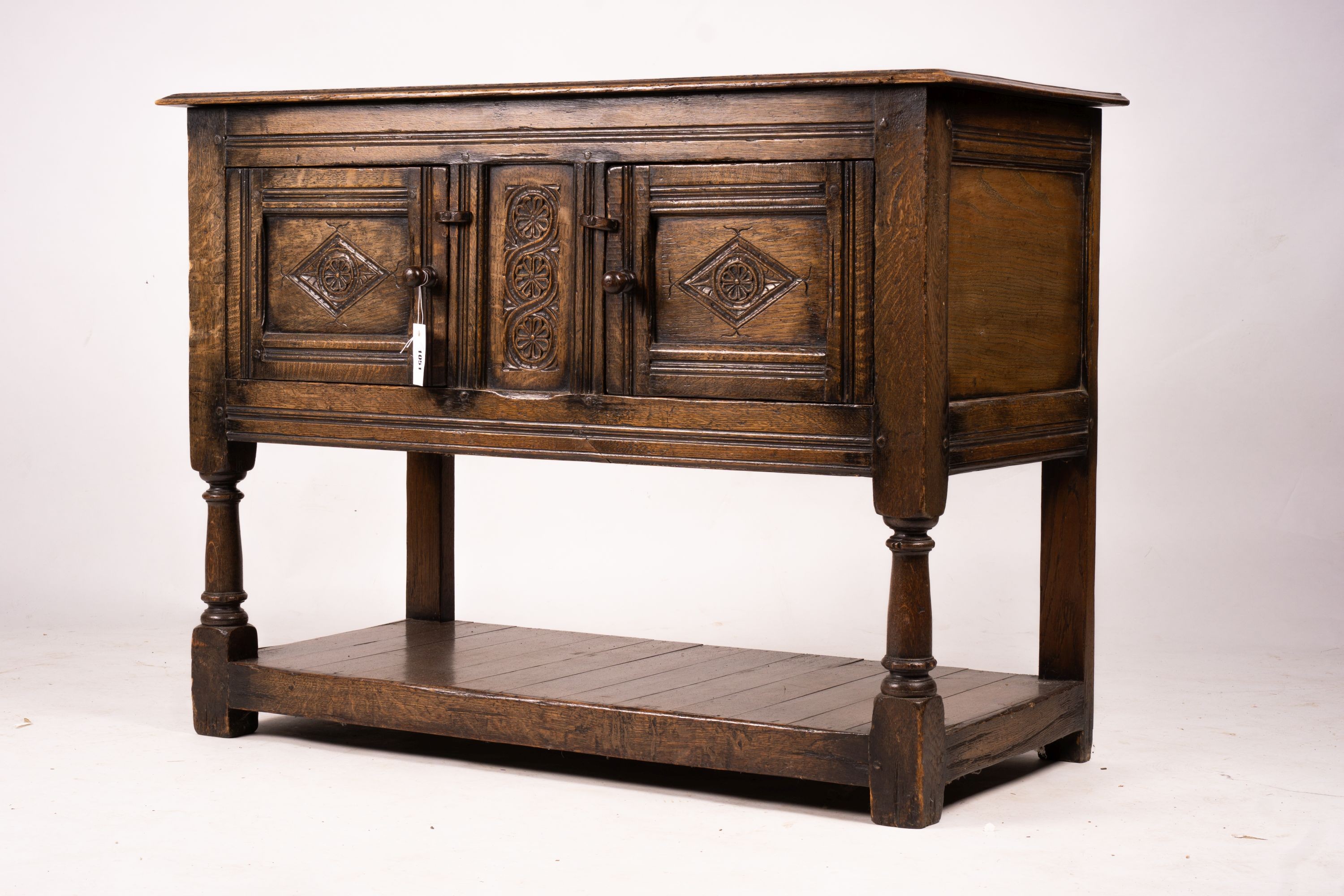 An 18th century style oak two door low cupboard, width 106cm, depth 50cm, height 78cm